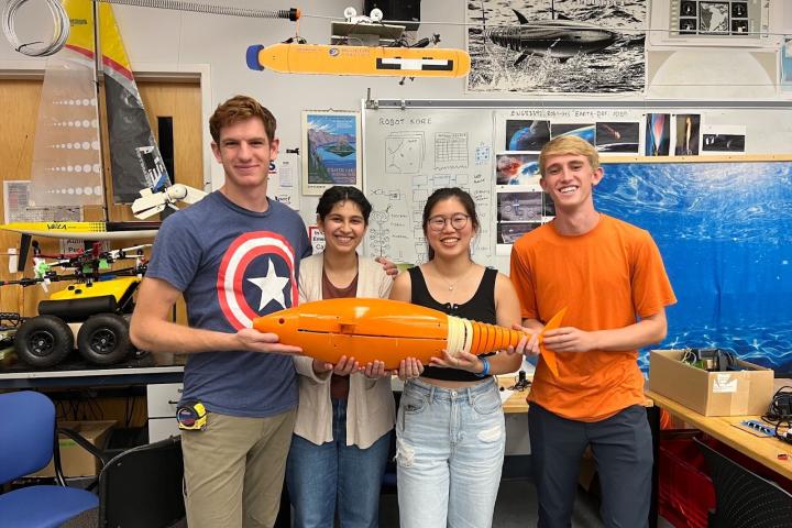 RoboLab fish project A group of students holding a robotic fish